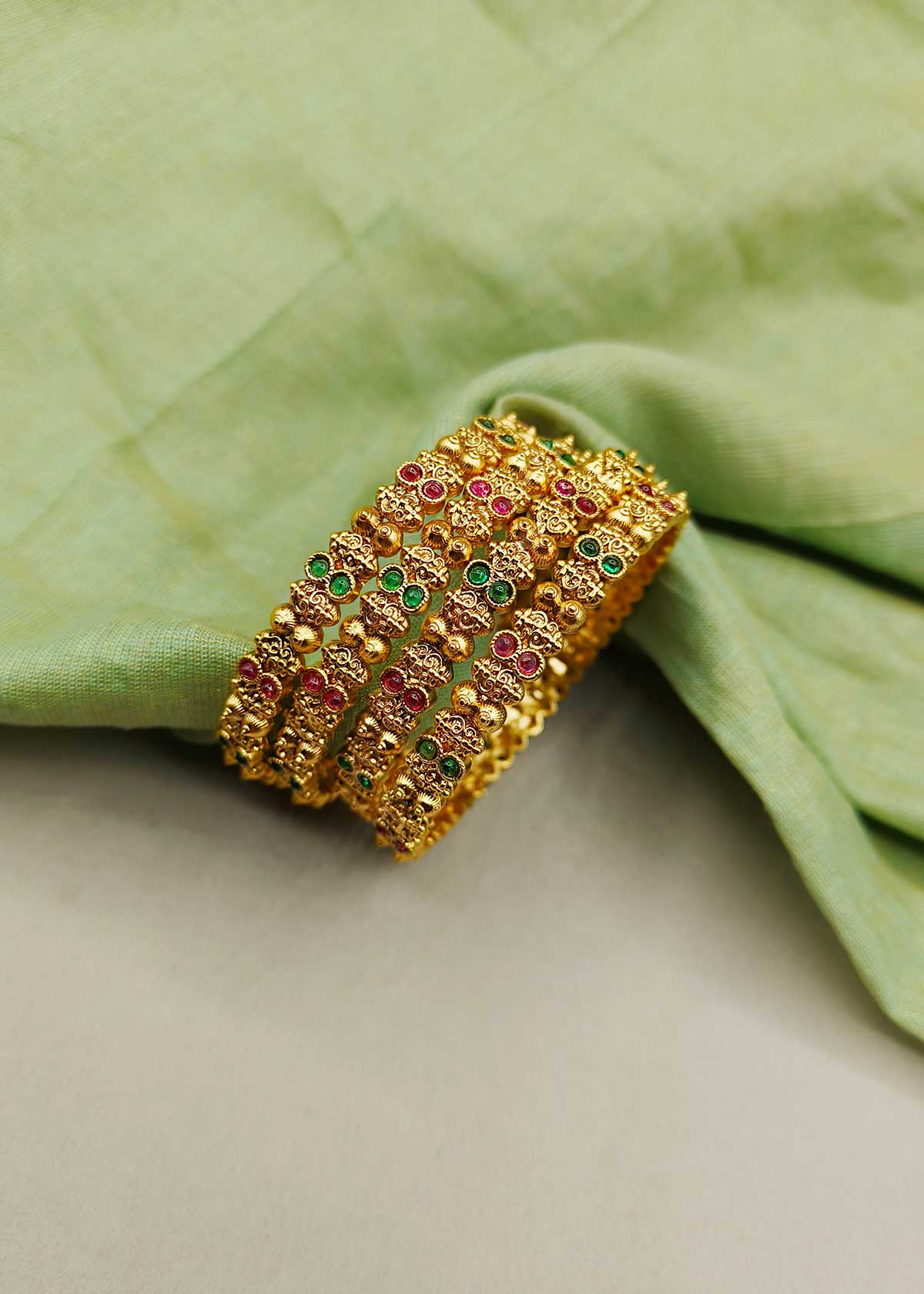 Vibrant Dual Tone Stone Studded Antique Gold Bangles (4 Pcs)