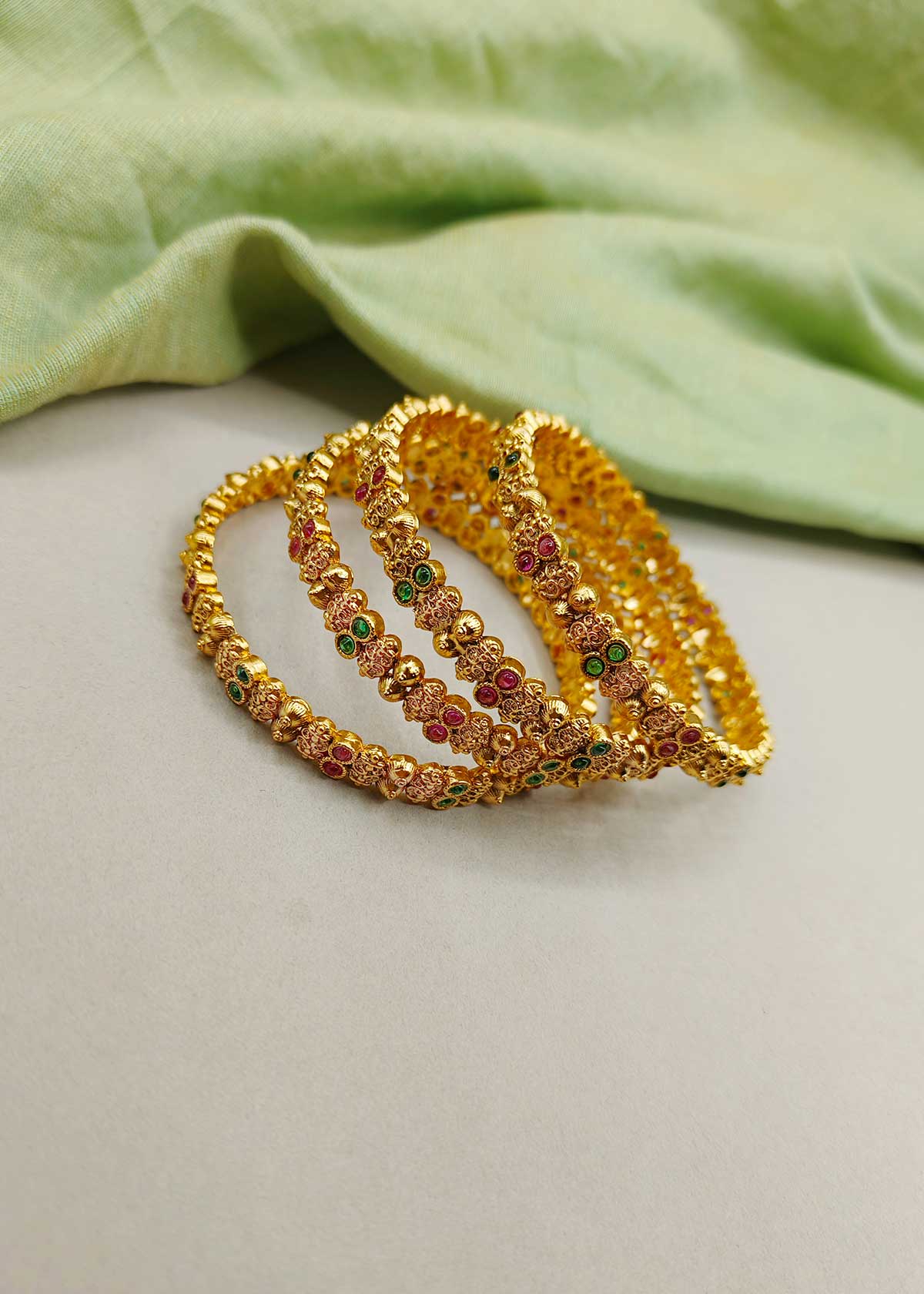 Vibrant Dual Tone Stone Studded Antique Gold Bangles (4 Pcs)